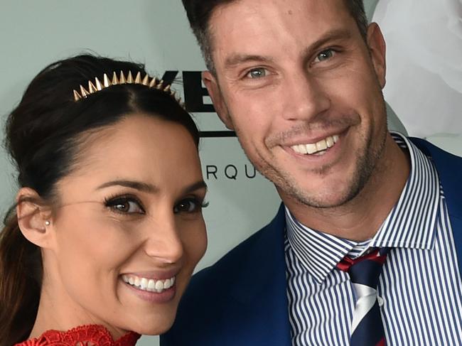 The Bachelor Sam Wood (right) and Snezana Markoski pose for photos in the Birdcage on Melbourne Cup Day at Flemington Racecourse in Melbourne, Tuesday, Nov. 3, 2015. (AAP Image/Julian Smith) NO ARCHIVING, EDITORIAL USE ONLY