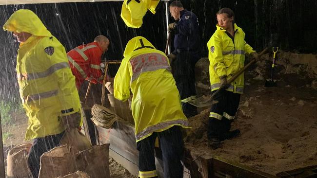 Firefighters and SES volunteers fill hundreds of sandbags at Banora Point, NSW, during the recent rains. Photo: Fire and Rescue NSW