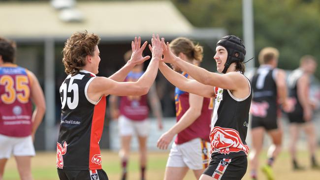 Kyle Beveridge (left) celebrates a goal for Devon Meadows.