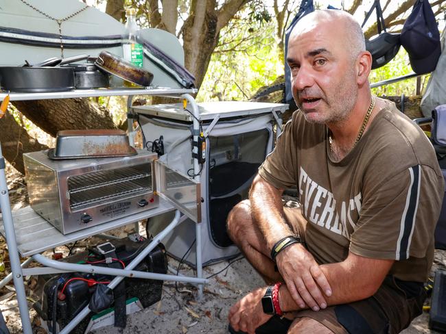 Andrew Felicissimo with his cooking oven at his camp along the Rosebud foreshore. He is homeless and although self sufficient and living off the grid in a tent, he needs a home to live in. Picture: Ian Currie