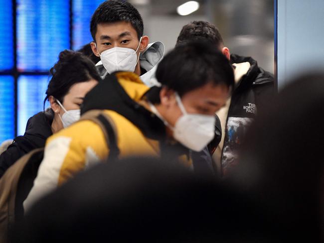 Passengers of a flight from China walk towards the Covid-19 testing centre after arriving at the Paris-Charles-de-Gaulle airport in Roissy, outside Paris. Picture: AFP