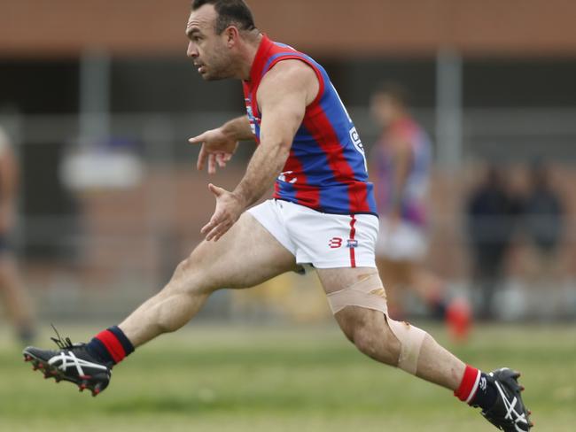 Georgie Angelopoulos booting Springvale Districts forward.