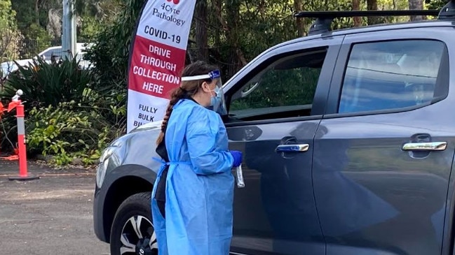 Testing centre staff at 4Cyte Capalaba talk to a resident.