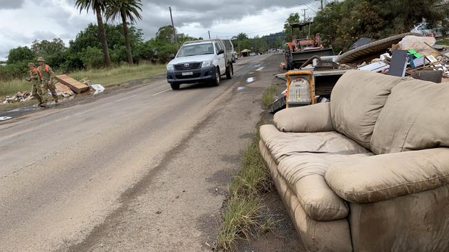 Army personnel go house to house in North Lismore while helping a flood response on Saturday. Picture: Stuart Cumming