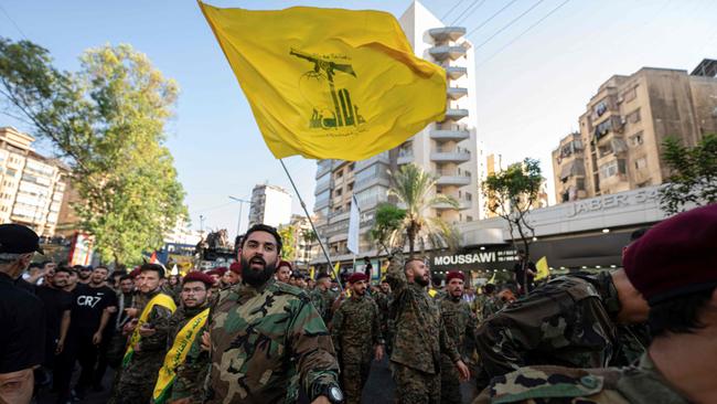 Hezbollah fighters form a human barrier during the funeral procession of slain top Hezbollah commander Fuad Shukr. Picture: Khaled Desouki/AFP