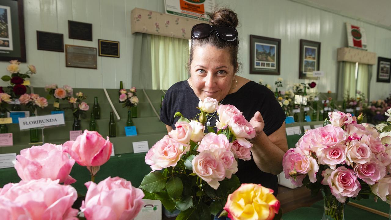 Nardia Booshand of the Friends of the Queensland State Rose Garden admires the entries in the 2022 Spring Champion Rose Show at the Rose Cottage in the Queensland State Rose Garden, Saturday, October 8, 2022. Picture: Kevin Farmer