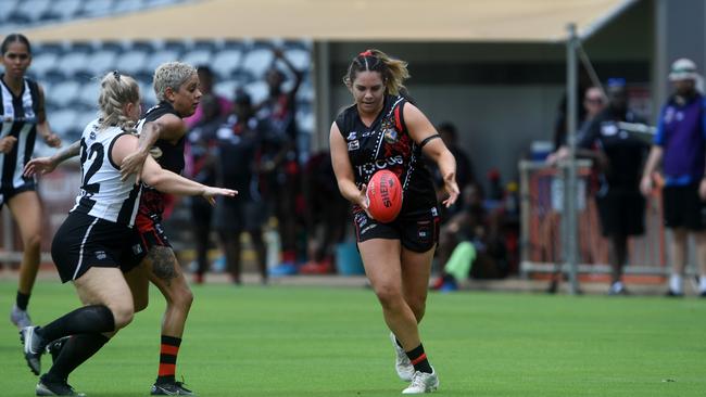 Tiwi Bombers Rhiannon Busch pushes the ball forward in the NTFL 2022-23 season opener against Palmerston Magpies. Picture: (A)manda Parkinson