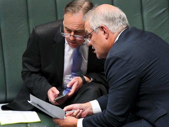 Australian Prime Minister Scott Morrison (right) speaks to Australian Health Minister Greg Hunt during House of Representatives Question Time at Parliament House in Canberra, Tuesday, June 1, 2021. (AAP Image/Lukas Coch) NO ARCHIVING