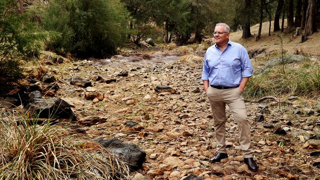 Australian Prime Minister Scott Morrison stands in a dry riverbed while visiting the Dungowan Dam near Tamworth in 2019. Picture: Adam Taylor/PMO