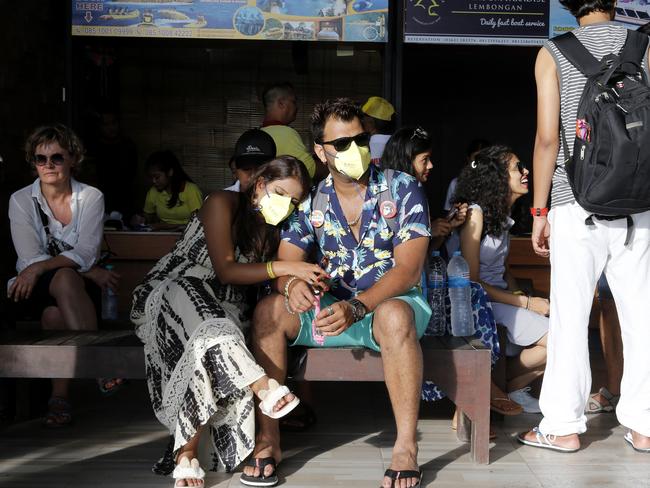 Bali tourists wait for their departure at a harbour as tourism on the resort island has fallen due to the coronavirus outbreak. Picture: AP