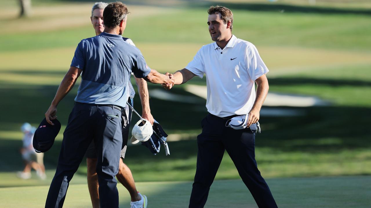 Adam Scott of Australia reacts with Scottie Scheffler of the United States on the 18th green during the third round of the BMW Championship at Wilmington Country Club. Photo: Getty Images