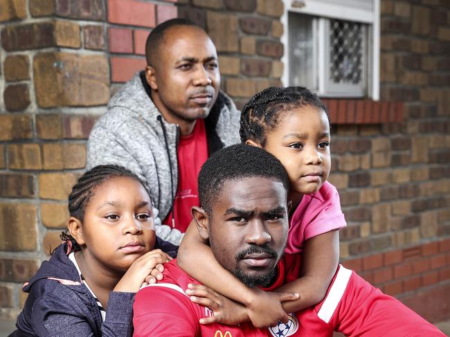 SOCCER -  Daniel Dume 46, with 3 of his 5 children  Pacifique Niyongabire, 20, Daniella Nishimwe, 8 and Nella Uwimana, 5. All waiting for their wife and mother to be allowd to travel home from Africa where she was attending a wedding. Picture SARAH REED