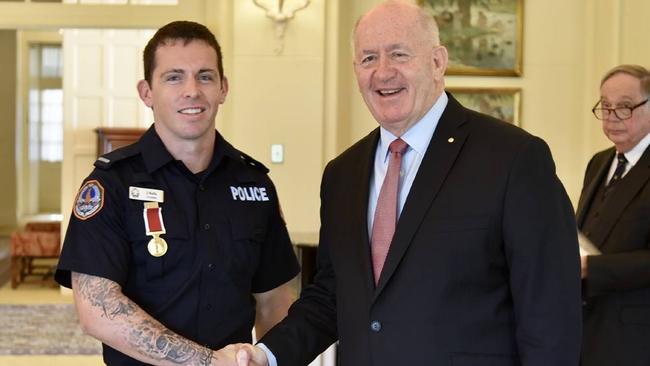 Zachary Rolfe had only been a cop for a week when he rescued two tourists from a flood-swollen river, earning the Royal Humane Society's highest bravery award at a ceremony with then-Governor General Peter Cosgrove.