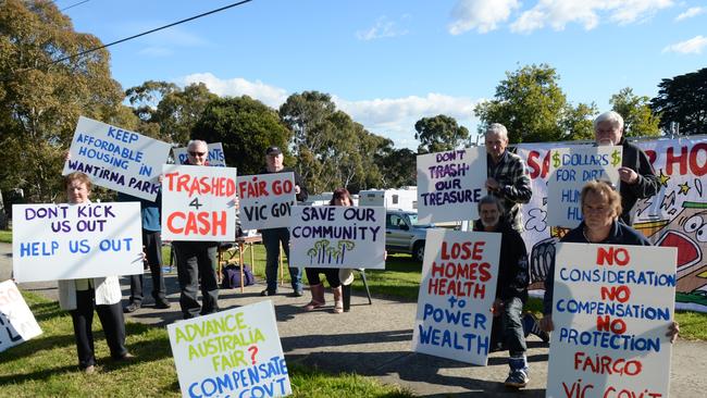 Wantirna Caravan park residents waving signs and banners beside Mountain Highway.