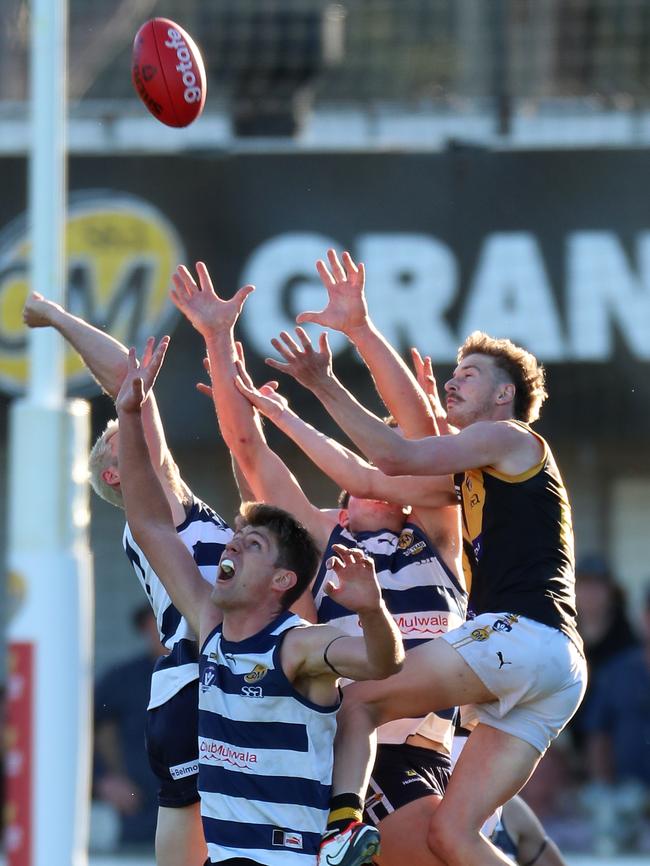 Albury’s Riley Bice arrives late to fly over three Yarrawonga opponents in the grand final.