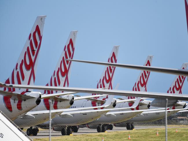 Virgin Australia planes parked on the tarmac at Adelaide Airport in Adelaide, Tuesday, April 21, 2020. The airline has gone into voluntary administration. (AAP Image/David Mariuz) NO ARCHIVING