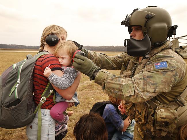 Terrified children were among the last evacuees from Mallacoota in Victoria Sunday. Picture: David Caird