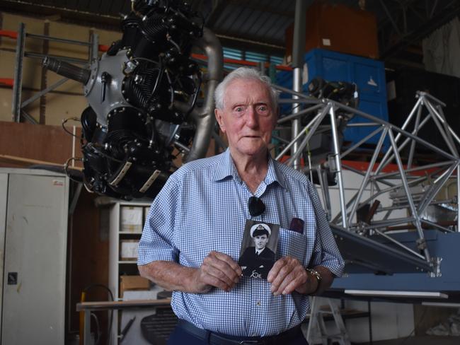 Peter Groom holds a photo of his younger self of when he served in the Royal Navy Fleet Air Arm during World War Two. Photo: Stuart Fast