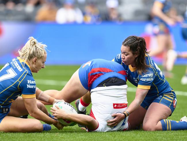 SYDNEY, AUSTRALIA - AUGUST 06: Laishon Albert-Jones of the Knights is tackled by Kennedy Cherrington of the Eels and Madeline Jones of the Eels during the round three NRLW match between Parramatta Eels and Newcastle Knights at CommBank Stadium, on August 06, 2023, in Sydney, Australia. (Photo by Brett Hemmings/Getty Images)