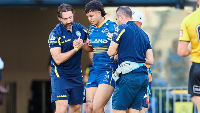 Haze Dunster is helped from the field. Picture: Brett Hemmings/Getty Images