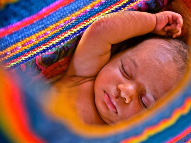 Sibilato’s new born babay girl, sleeping in a traditional woven Bilum. Picture: Alegra Ally