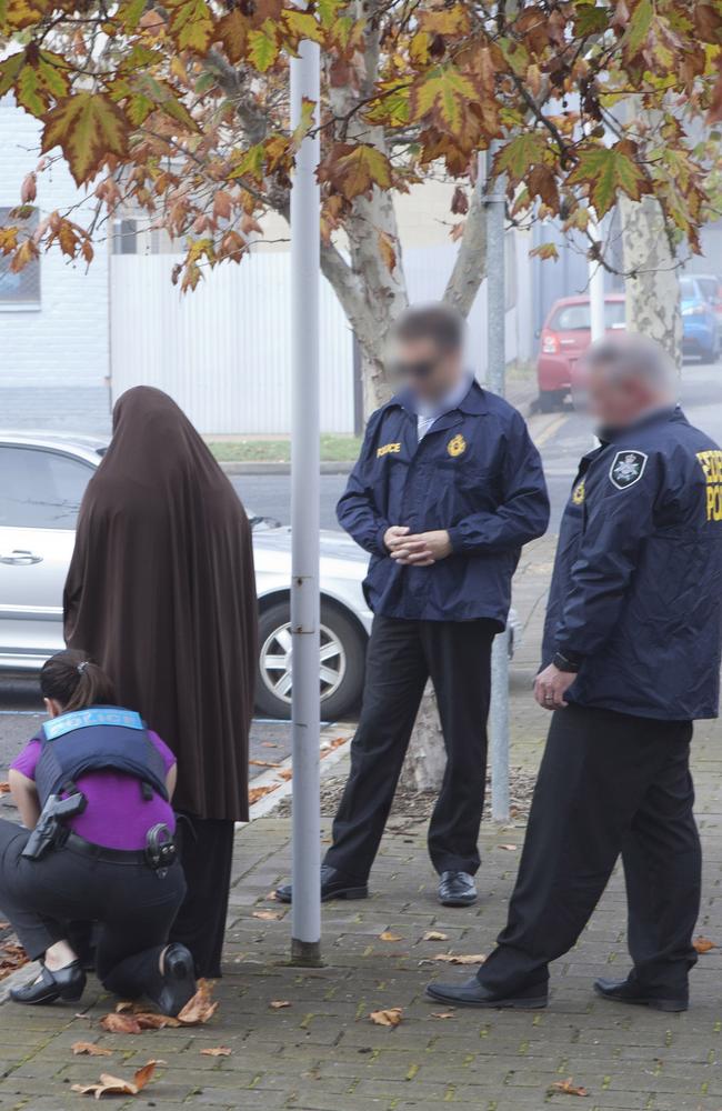 Australian Federal Police arrest the woman before laying charges. Picture: AFP