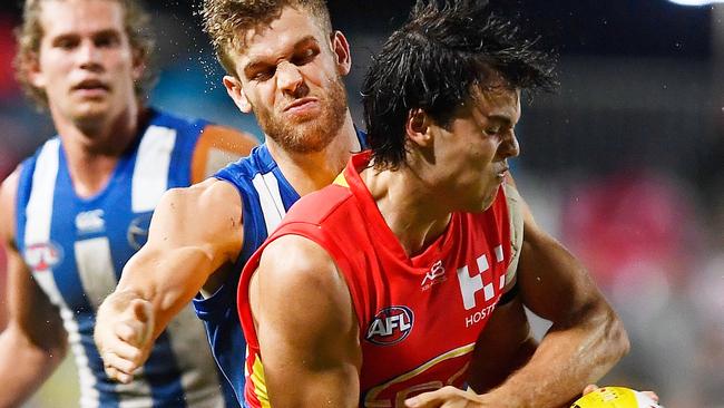 Jack Bowes of the Suns is tackled during the round one AFL match between the Gold Coast Suns and the North Melbourne Kangaroos at Cazaly's Stadium on March 24, 2018 in Cairns, Australia. (Photo by Ian Hitchcock/Getty Images)