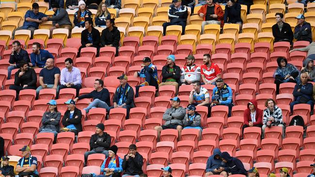 Socially distanced spectators watch the Round 6 NRL match between the Gold Coast Titans at the St George Illawarra Dragons at Suncorp Stadium in Brisbane. (AAP Image/Dan Peled)