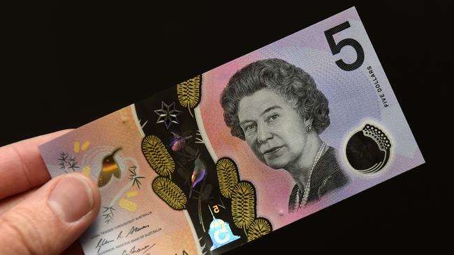 A new Australian five dollar banknote is displayed in Sydney on Thursday, Sept. 1, 2016. The new note, which came into circularion today, arose following a campaign from 15-year-old Connor McLeod, who is visually impaired, that amassed 57,000 supporters targeting the Reserve Bank of Australia. (AAP Image/Paul Miller) NO ARCHIVING