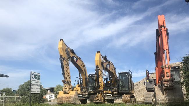 A man has died in a workplace incident involving heavy machinery in Pinkenba.