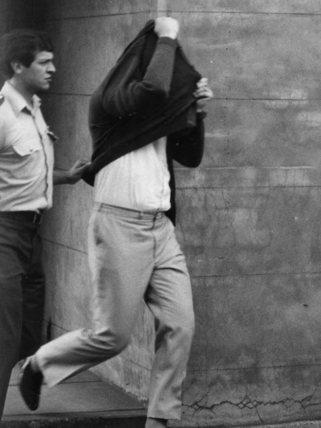 Bevan Spencer von Einem hides from the cameras as he faces court in 1984.