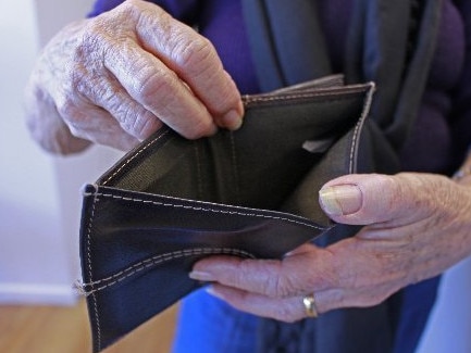 A man holds an open wallet, it's empty of money