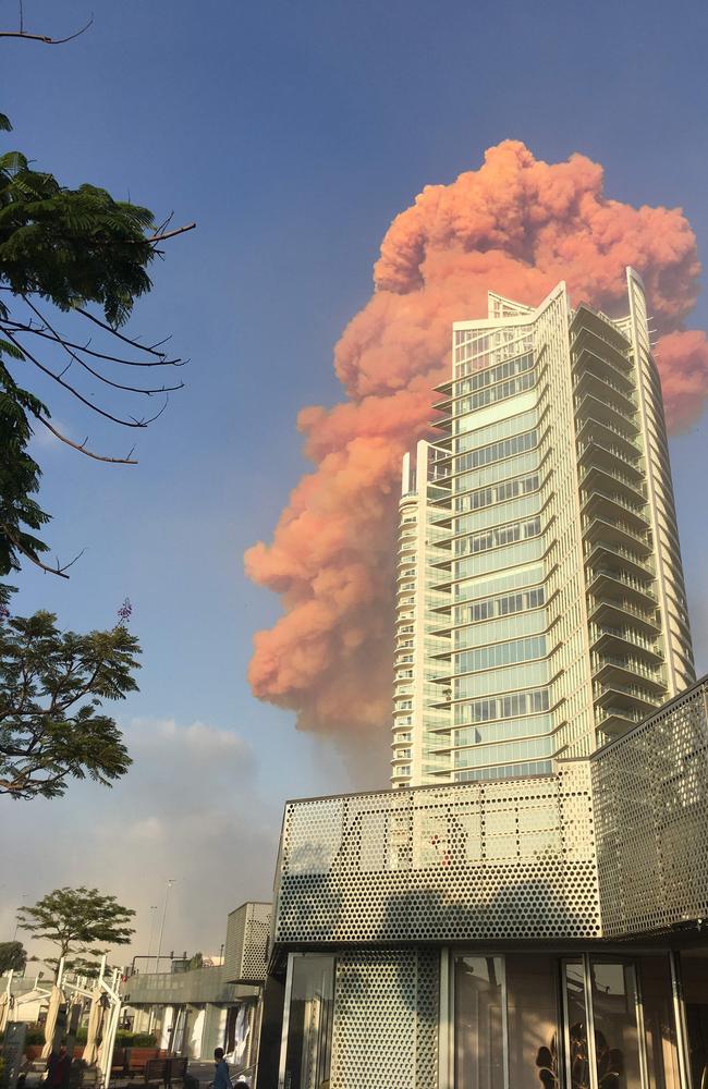 A photo taken from Zaytouna Bay shows a red plume of fire behind a high-rise in central Beirut. Picture: Bassem El Hage/AFP