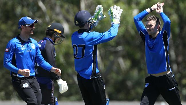 Jacob Pawlowicz celebrates a wicket with Nick Dixon against Melbourne University. Picture: Hamish Blair