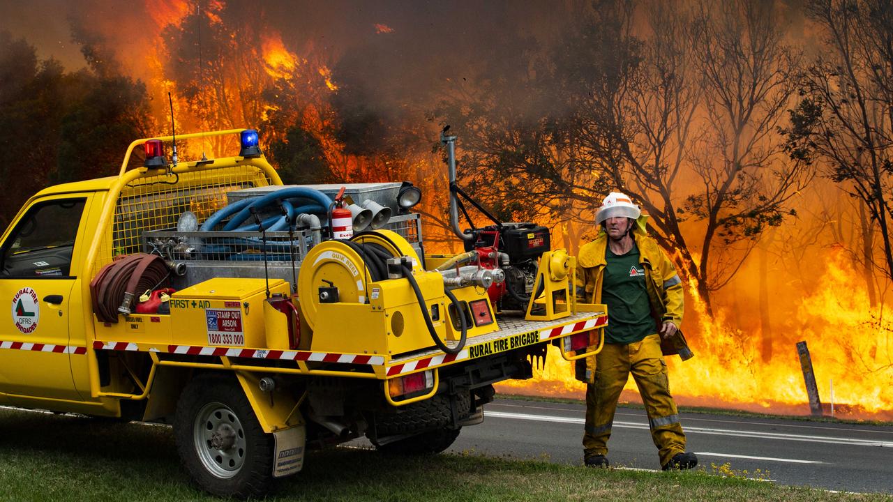 Firefighters on scene south of Peregian Beach as water bombing helicopters were called in to fight the wild bushfire. Photo Lachie Millard