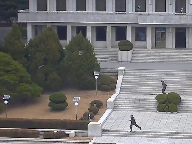 North Korea soldiers reacting to the news of a defection from Panmungok. Picture: AFP