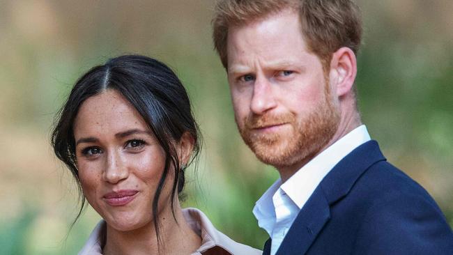 TOPSHOT - Britain's Prince Harry, Duke of Sussex(R) and Meghan, the Duchess of Sussex(L) arrive at the British High Commissioner residency in Johannesburg where they  will meet with Graca Machel, widow of former South African president Nelson Mandela, in Johannesburg, on October 2, 2019. - Prince Harry recalled the hounding of his late mother Diana to denounce media treatment of his wife Meghan Markle, as the couple launched legal action against a British tabloid for invasion of privacy. (Photo by Michele Spatari / AFP) / France OUT until 2019-10-17T00:00:00.000+02:00