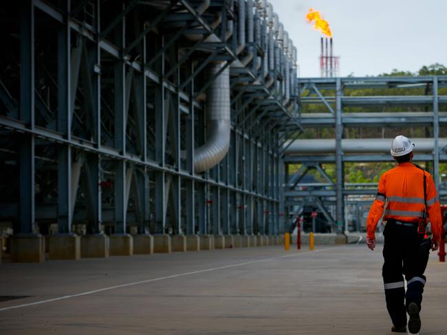 A worker walks through the Queensland Curtis Liquefied Natural Gas (QCLNG) project site, operated by QGC Pty, a unit of Royal Dutch Shell Plc, in Gladstone, Australia, on Wednesday, June 15, 2016. Gas from more than 2,500 wells travels hundreds of miles by pipeline to the project, where it's chilled and pumped into 10-story-high tanks before being loaded onto massive ships. Photographer: Patrick Hamilton/Bloomberg via Getty Images