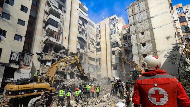 Rescuers on Saturday sift through the rubble at the scene of an Israeli strike that targeted Beirut's southern suburbs a day earlier. Picture: AFP