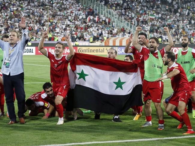 Syria's players celebrate.