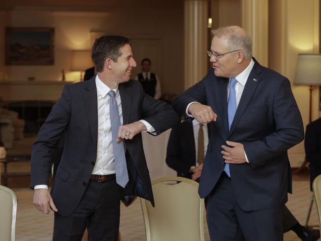 Simon Birmingham greets Prime Minister Scott Morrison before being sworn is as Finance Minister by the Governor General Peter Hurley at Government House in Canberra. Picture by Sean Davey.