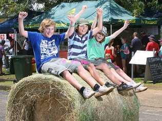 Thomas Yarrow, Steven Miller and Windston Olive perch precariously on one of the many bales of hay decorating Kalbar town on the weekend.