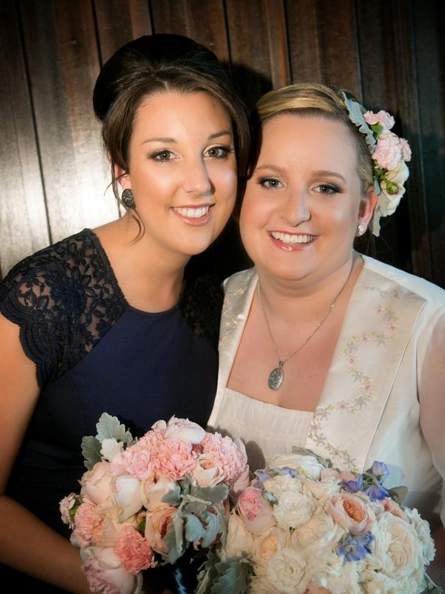 Eloise Baker-Hughes, with her bridesmaid Danielle Snelling, on her wedding day wearing her late mother’s wedding gown. Picture: Brenna Matthews