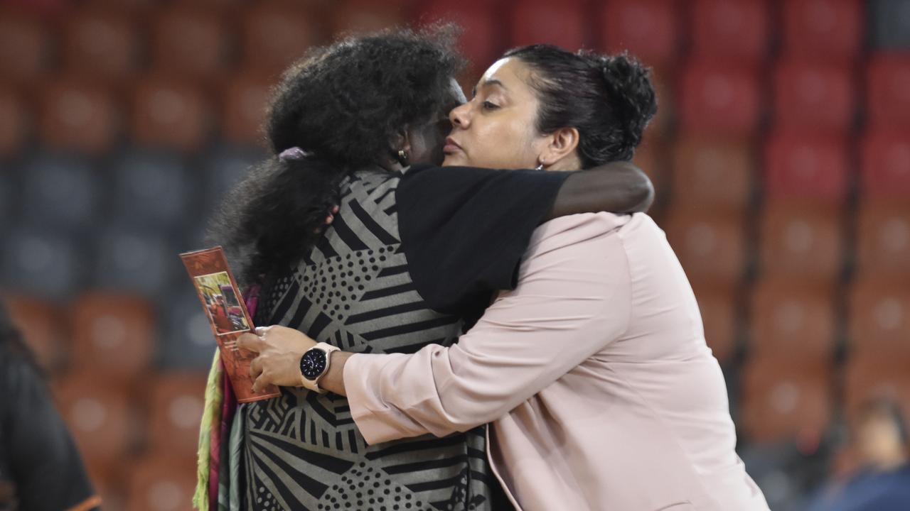 Karama MLA Ngaree Ah Kit embraces a fellow mourner at the state funeral for Dr Bush Blanasi on Friday, December 15.