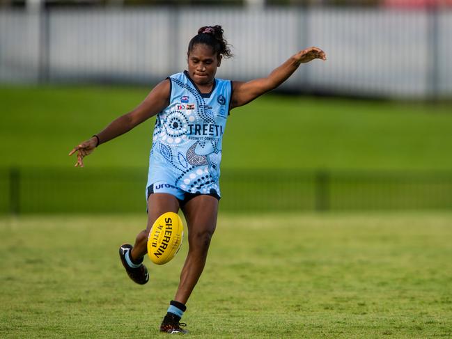 Darwin Buffette Ashanti Bush with a boot to the footy. Picture: Che Chorley