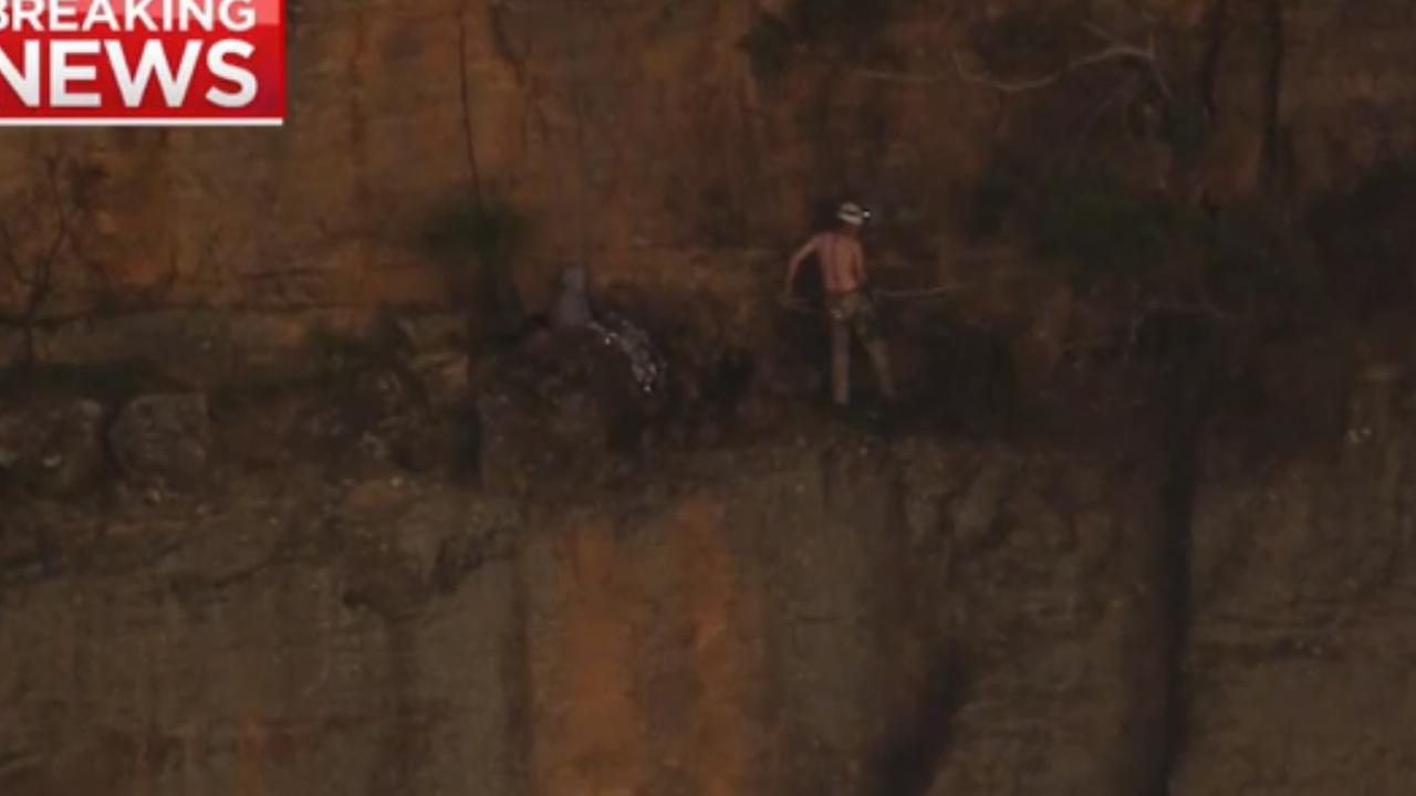 The stranded climber clings to a one metre wide ledge.