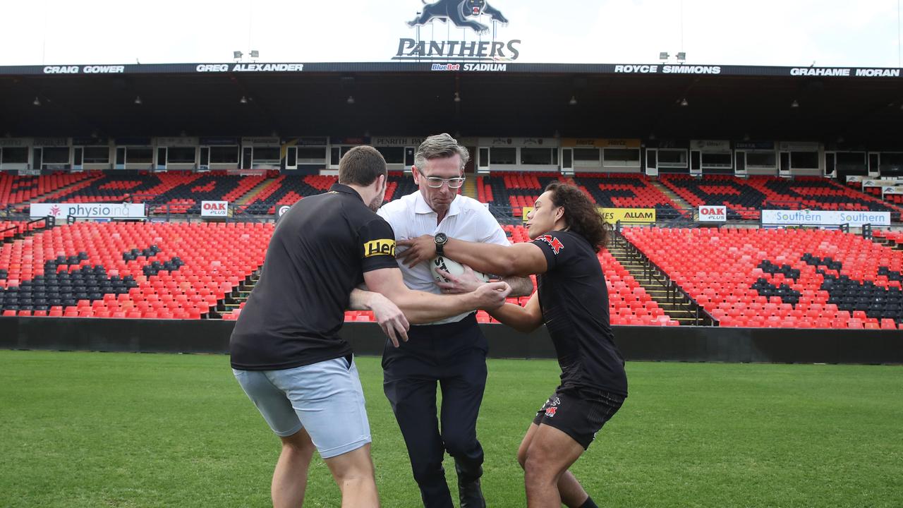 NSW Premier, Dominic Perrottet announces funding for a new stadium at Penrith. Perrotett has a run around with Penrith Players, Jerome Luai (right) and Team Captain, Isaah Yeo (left). Picture: NCA NewsWire / David Swift