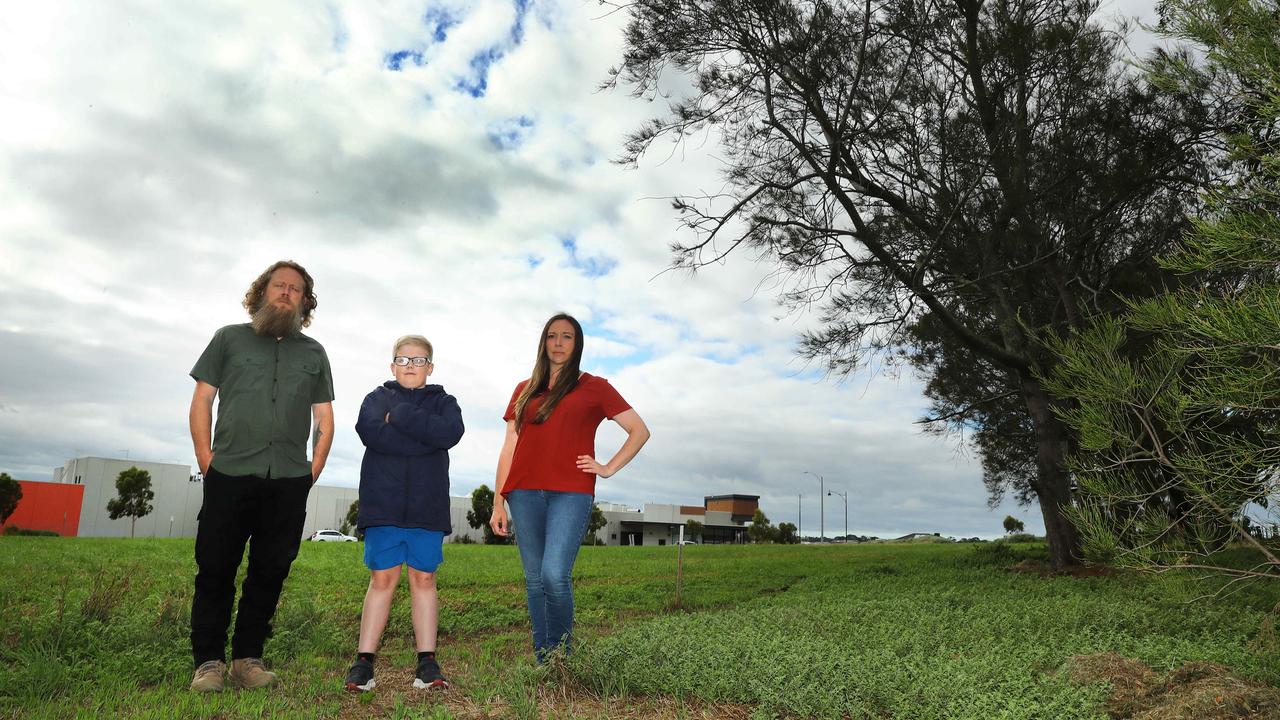 Chris Conner, son Liam and Sarah Ludvig at the site where the Curlewis Community Health hub was supposed to be completed by 2023. Picture: Alison Wynd