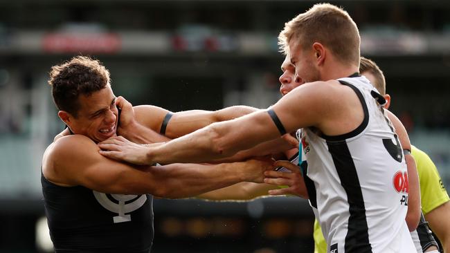 Carlton’s Ed Curnow wrestles with Port’s Dougal Howard. Picture: Michael Willson/AFL Media/Getty Images