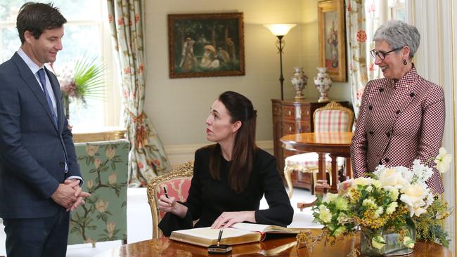 Governor of Victoria Linda Dessau (right) is seen with the New Zealand Prime Minister Jacinda Ardern (centre) and her partner Clarke Gayford at the signing of the visitor book at Government House in Melbourne. Picture: David Crosling/AAP